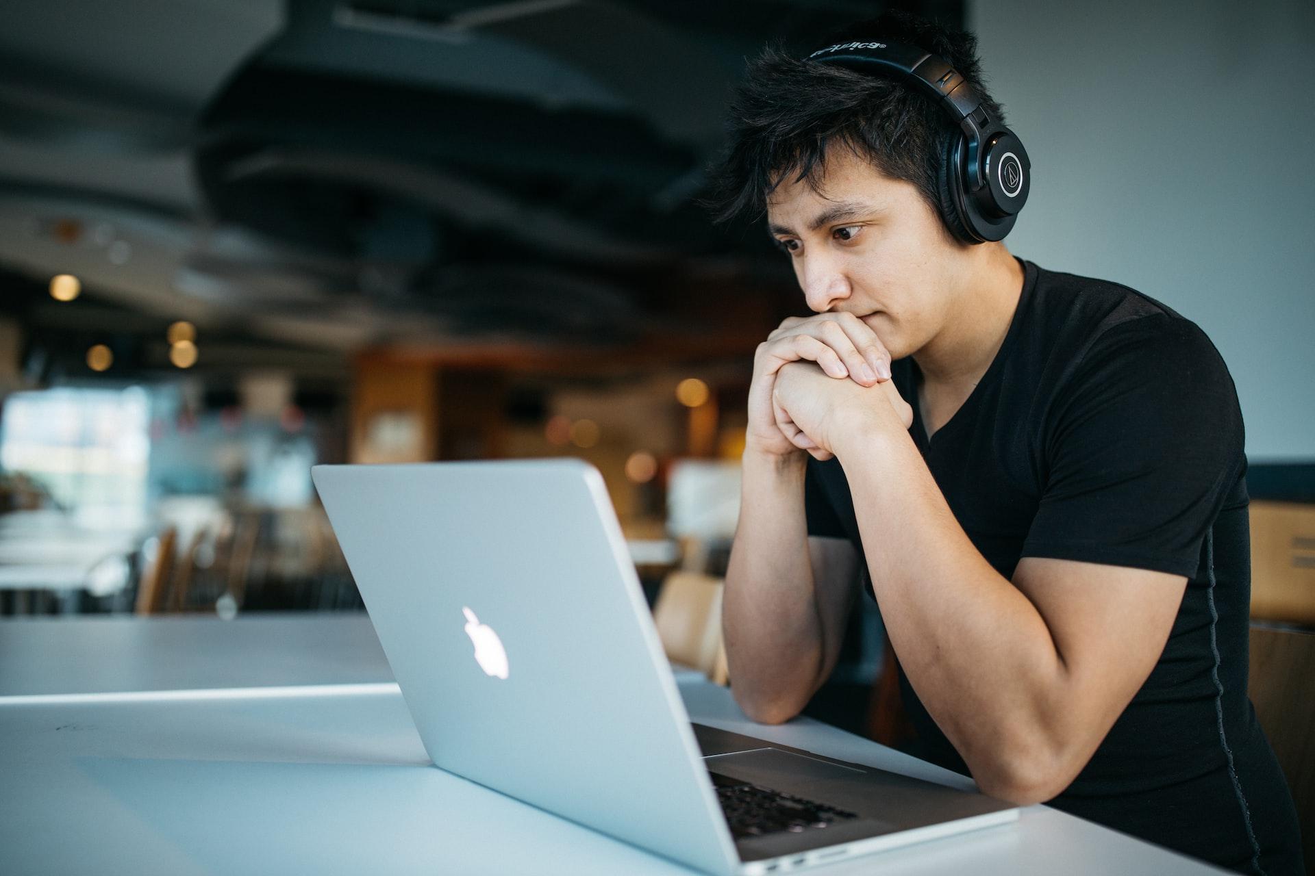 Man looking at Apple laptop