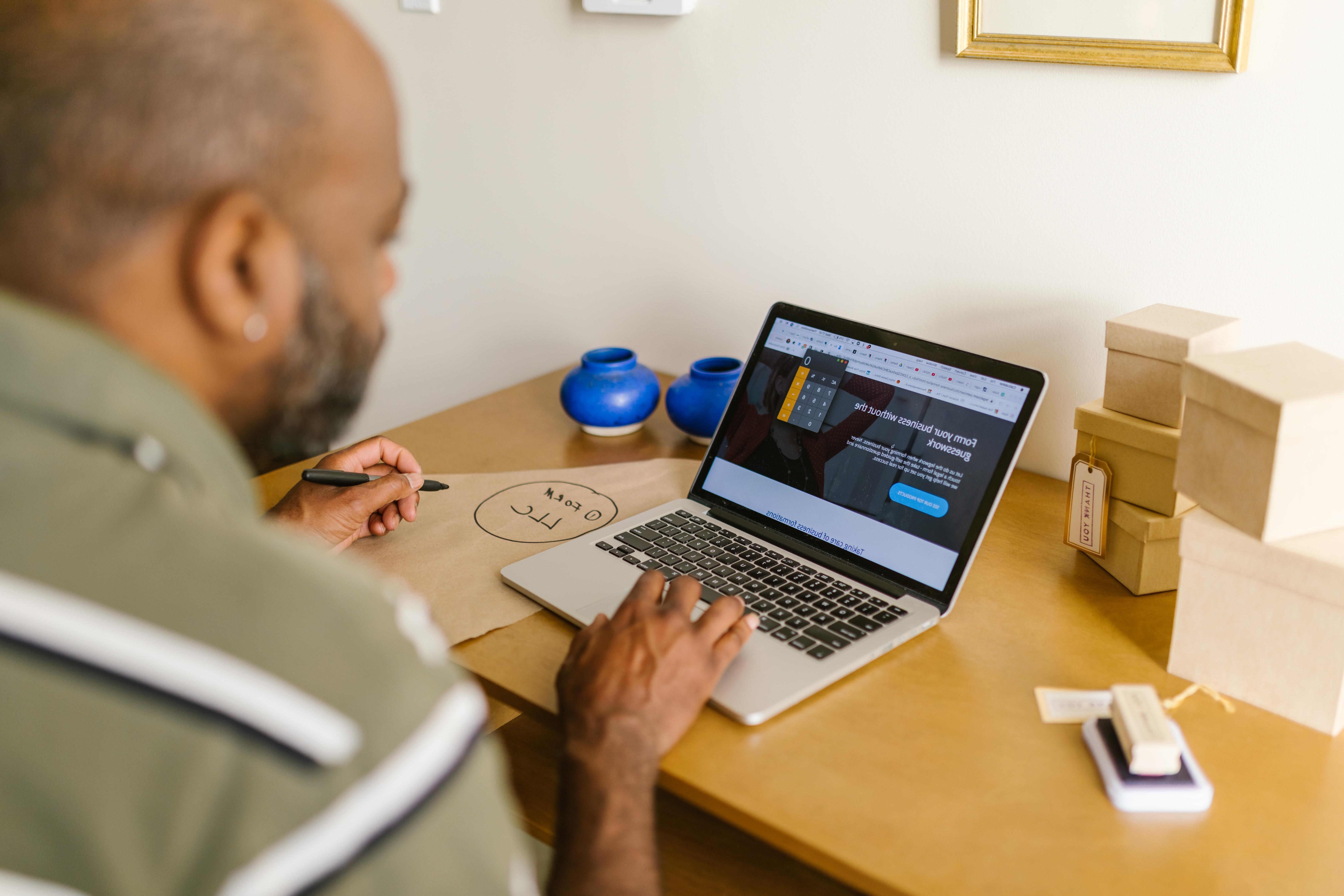 Man writing accessibility statement on laptop