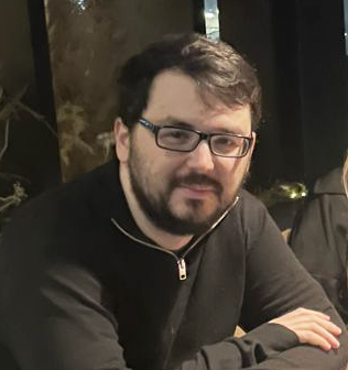 A photo of Matthew sitting at a table